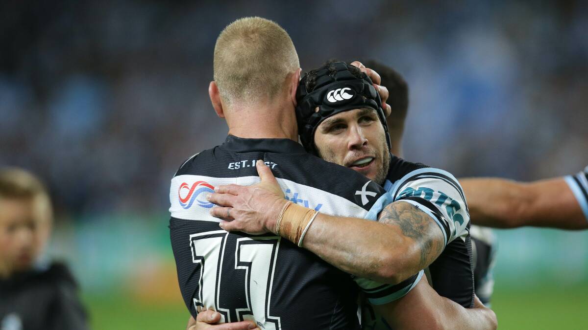 One game to go: Michael Ennis and Luke Lewis after the win over the Cowboys. Picture: John Veage 
