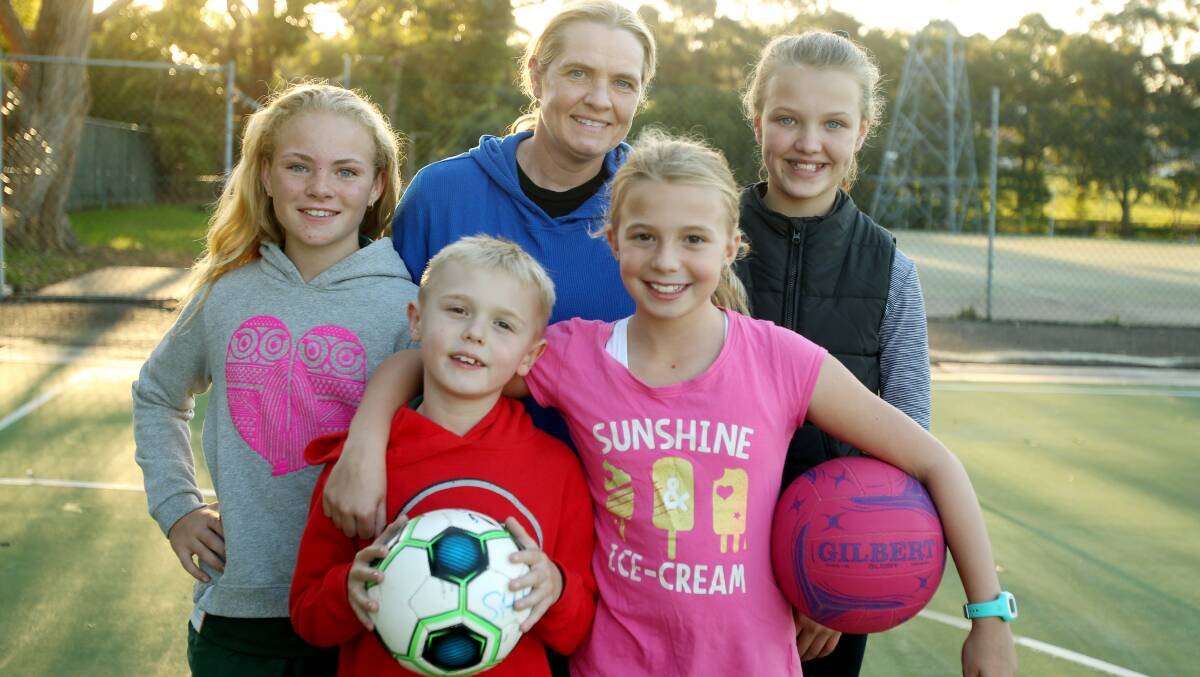 Sylvania Heights Netball Club coach Hayley Smith with her children Lucas, 8, and Chloe, 10, and other members of her under 11 team, Jacinta Laverance and Indie Shanahan. Picture: Chris Lane