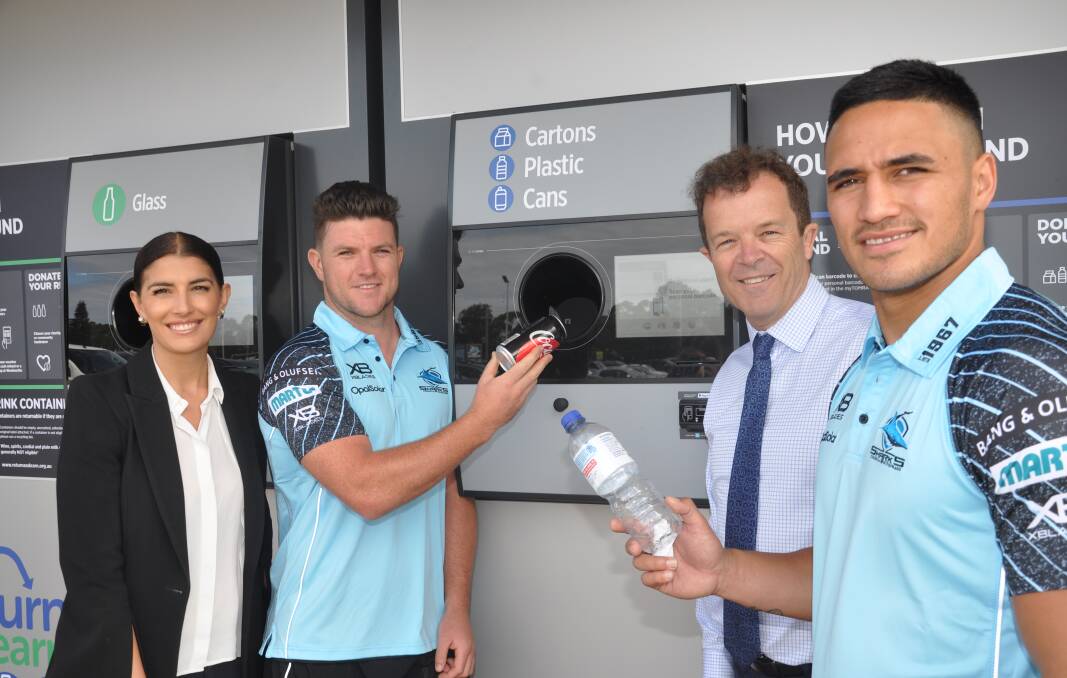 Sharks’ stars Chad Townsend and Valentine Holmes try out the new machines at the launch on Monday by state MPs Mark Speakman and Eleni Petinos.