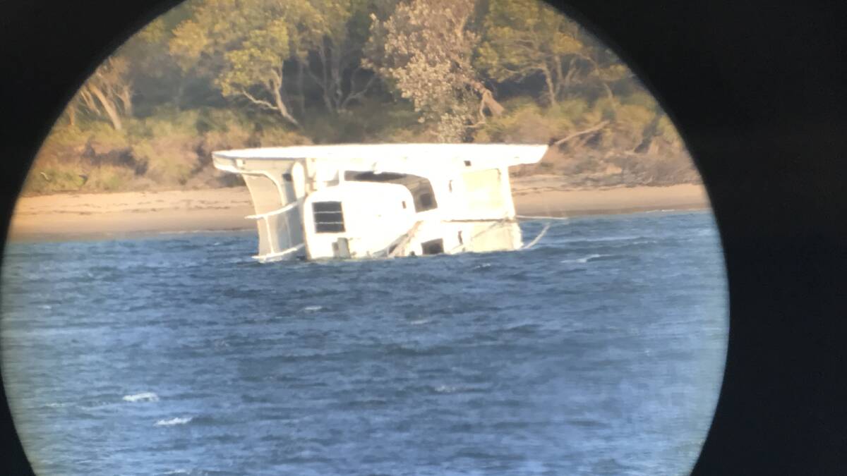The overturned catamaran near Bundeena. Picture: Marine Rescue Commissioner Stacey Tannos, who used the telescope in his office.
