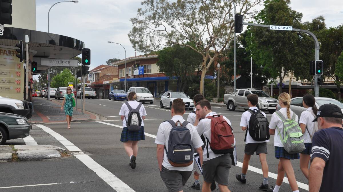 School students on the pedestrian crossing where the accident occurred earlier in the day.