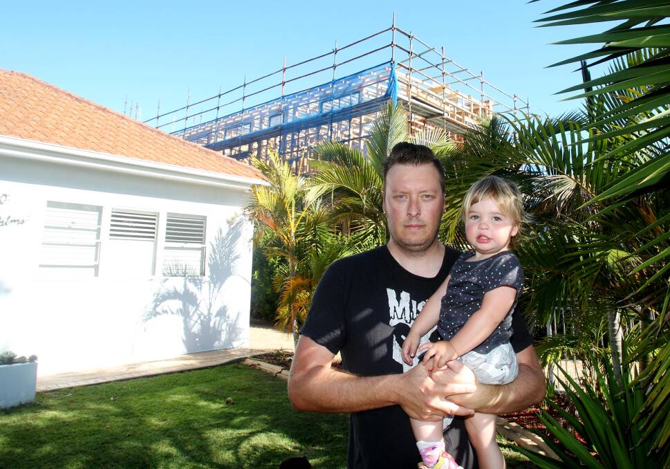 Neighbourhood impact:  Adam Newman, with daughter Matilda, says the council "let down nine hard-working families" who objected to the application for retrospective modifications to the development. Picture: Chris Lane 