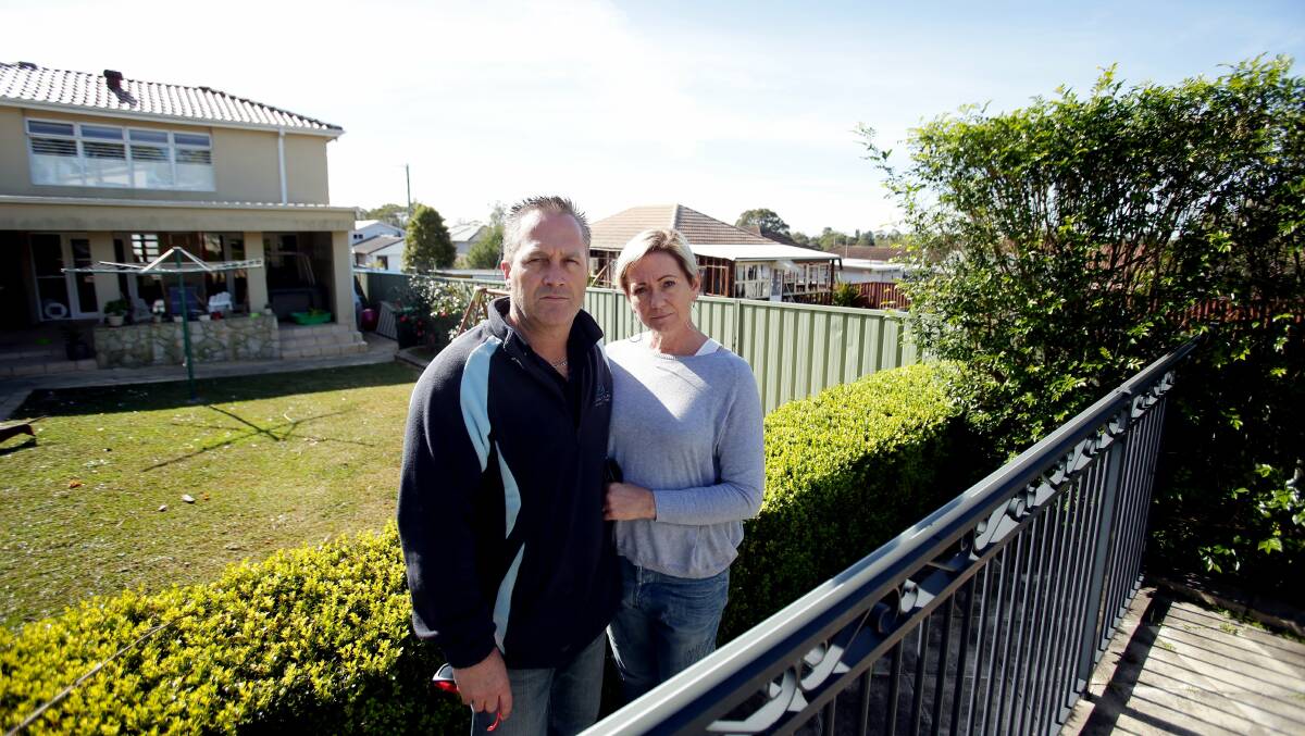 Development anger: Scott and Shirley Phillips say sunbaking around the pool will be over when  townhouses are built on the site in background, where the old house is about to be removed. Picture: Chris Lane