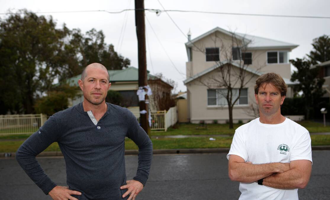 Health concerns: Andrew Camfield (right) and Mark Lavender in front of the pole on which the base station would be located. Picture: John Veage