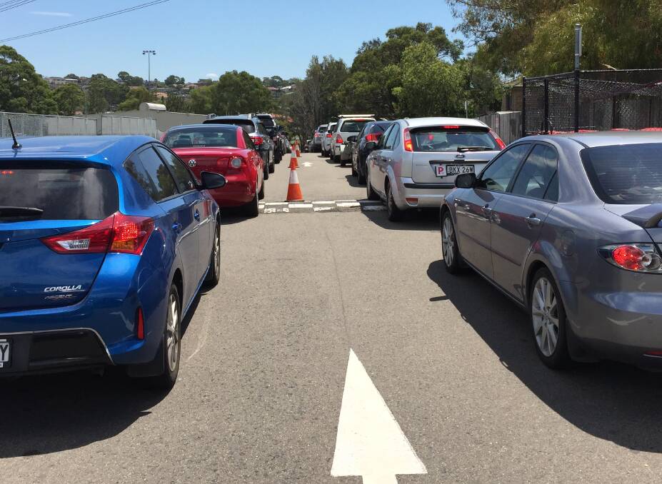 Patience needed: Motorists wait their turn in the Bellingara netball courts car park.
