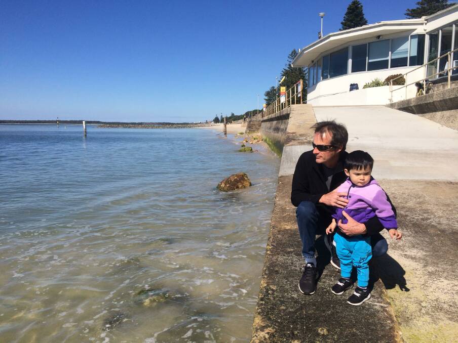 Beach disappears: Monterey resident Greg Kelly, with his son Luca, on the ramp leading to where beach has been replaced by water and potentially dangerous rocks.