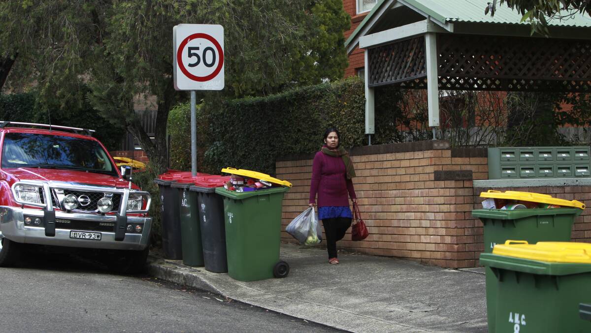 Garbage bins placed on the kerbside can “dominate the streetscape”, create traffic risks and take up much-needed parking. Picture: Louise Kennerley