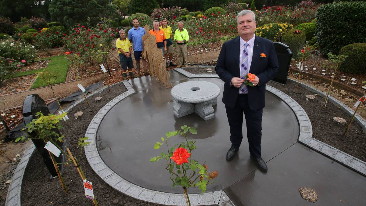 Wonderfully made: Graham Boyd with workers, who are putting the finishing touches to the new memorial, standing behind one of the sculptures. Picture: John Veage