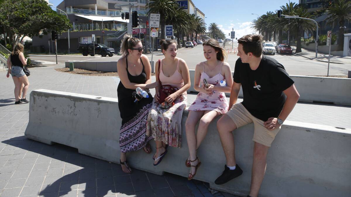 Safer spaces: A group of young people find newly installed barriers at the entrance to Peryman Square at North Cronulla have more than one use. Picture: John Veage