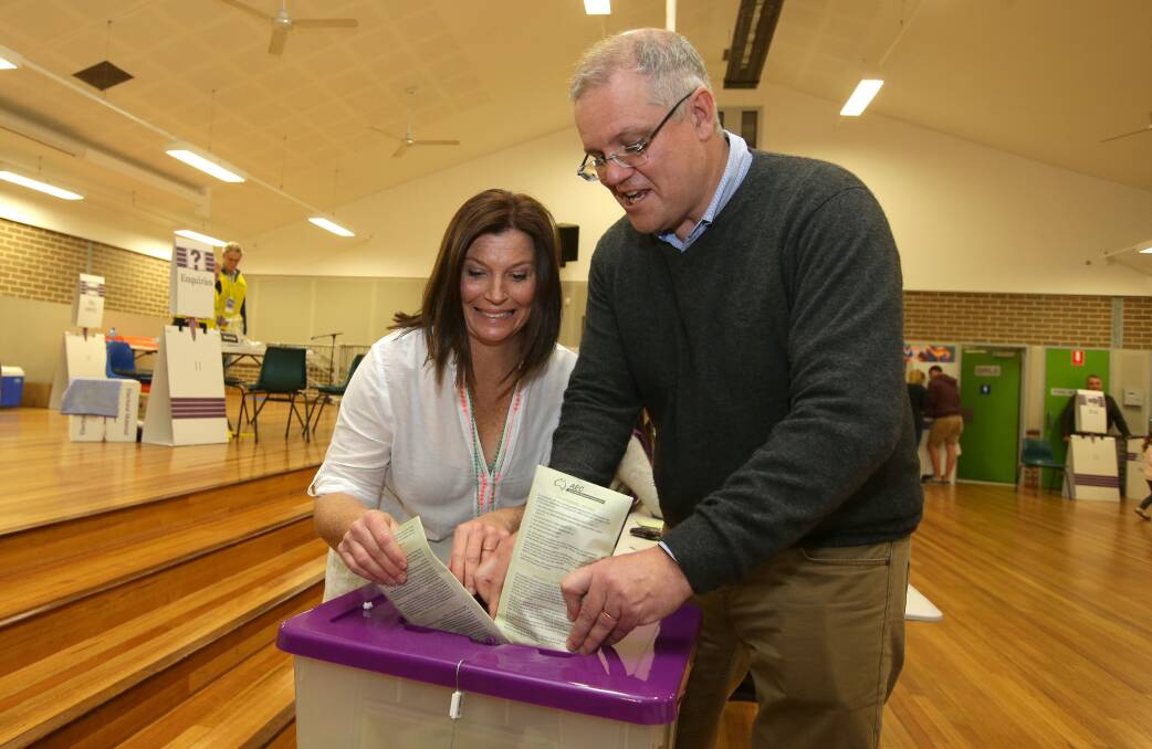 Scott and Jenny Morrison cast their votes at Lilli Pilli Primary School. Picture: John Veage