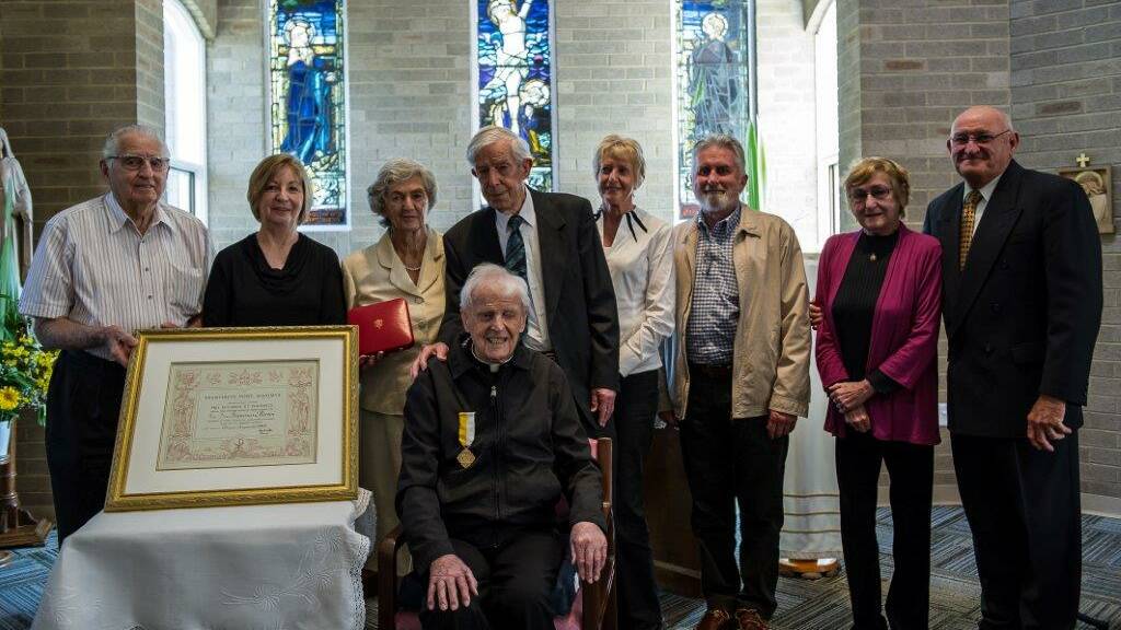 Papal honour: Father Frank Martin with the Papal Cross of Honour he received in October last year for his 75 years of service to the church. Picture: Catholic Archdiocese of Sydney