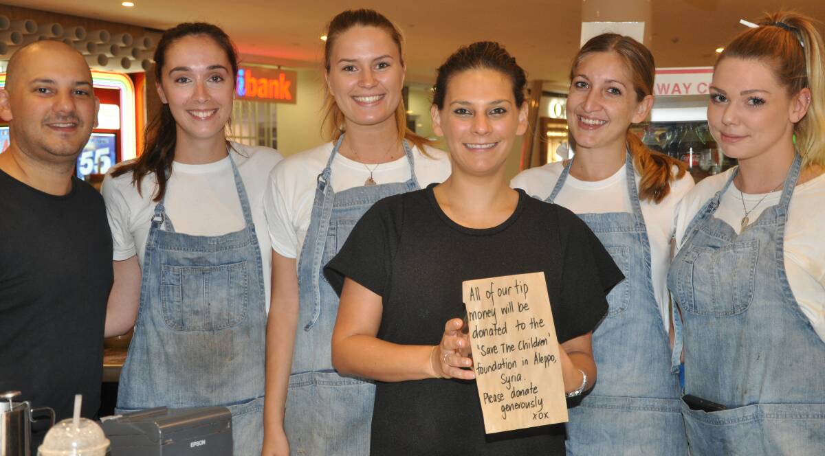 Help for children: Andrew Shalhoub, Sarah Johnston and staff members Emily, Chantel, Elle and Meghan with the sign.