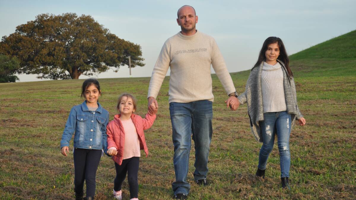 Concerned: John Thomas with daughters Ellie, 7, Alexia, 4, and Kiara, 9, in parkland opposite their home in Fraters Avenue, Sans Souci, where a stack is proposed.