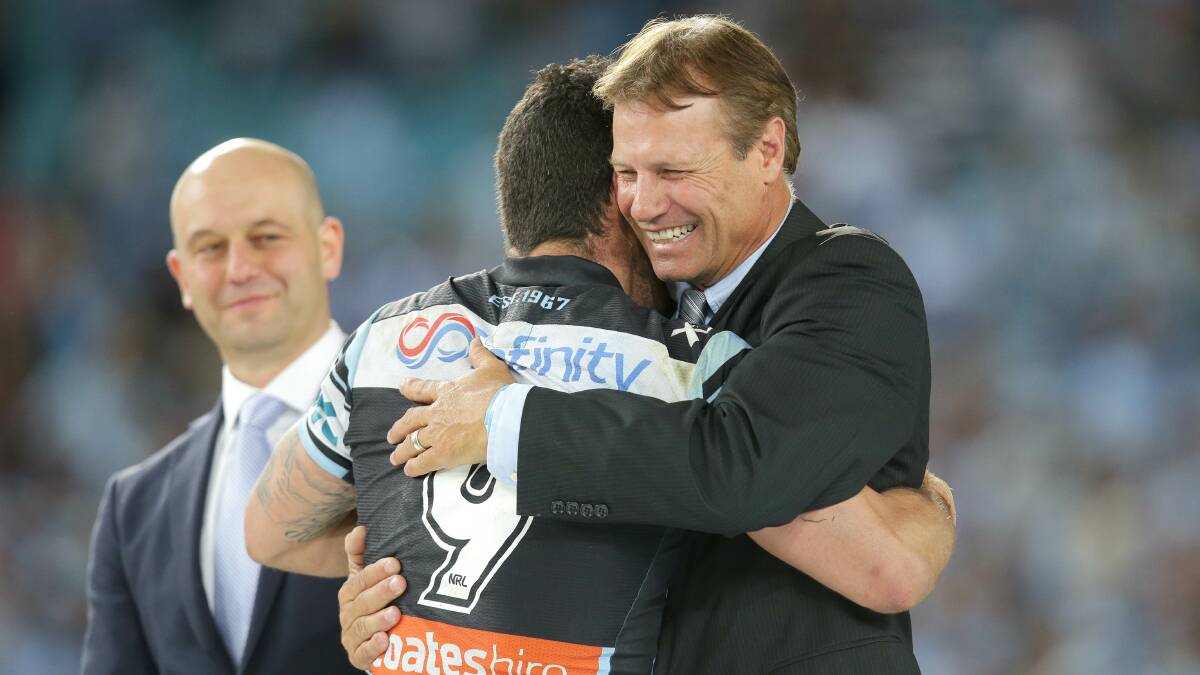 Past and present rejoice: Cronulla Sharks legend Andrew Ettingshausen congratulates retiring Michael Ennis after the grand final victory. Picture: John Veage