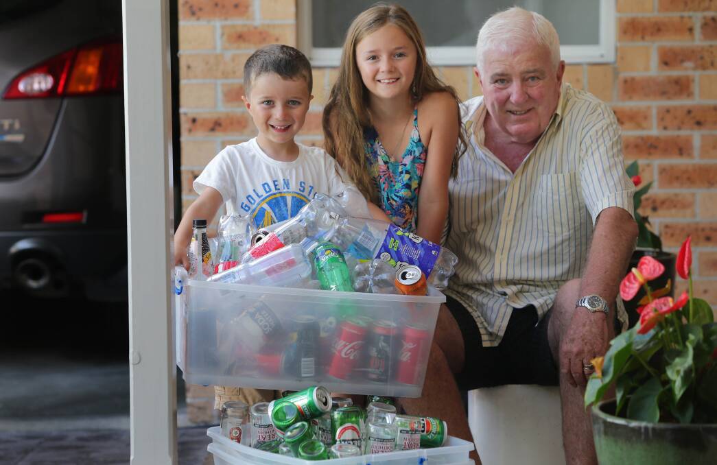 Return and earn: Greg Bleazard and grandchildren Carter (5) and Marley (8) with bottles collected for 10 cents refund. Picture: John Veage

