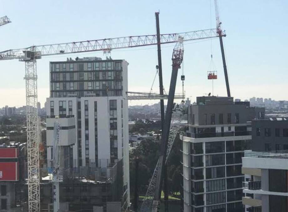 Response: Four mobile cranes move to slowly dissemble the collapsed tower crane.