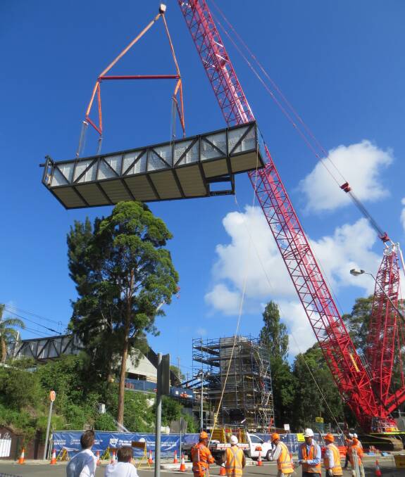 Lift off: Historic day as a walkway section is lifted into position. Picture: Robin Robertson
