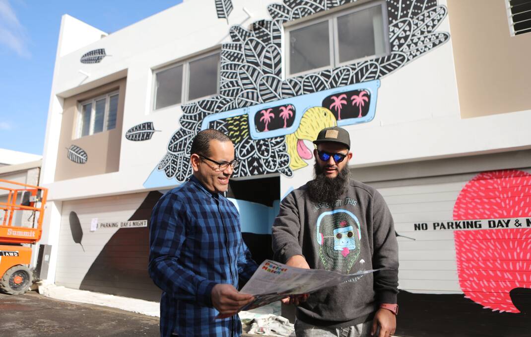 Perfect Match: Building owner Eberto Escandon and shire artist Joel Moore (Mulga) discuss the Inner West Council's anti-graffiti scheme. Picture: Daniel Munoz