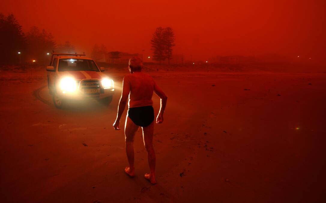 Memories persist of a strange day in 2009 when a red dust cloud blew in from the outback, blanketed Sydney, including St George and Sutherland Shire, and created eerie images such as this front page photo of an early morning swimmer at Cronulla. Picture: John Veage