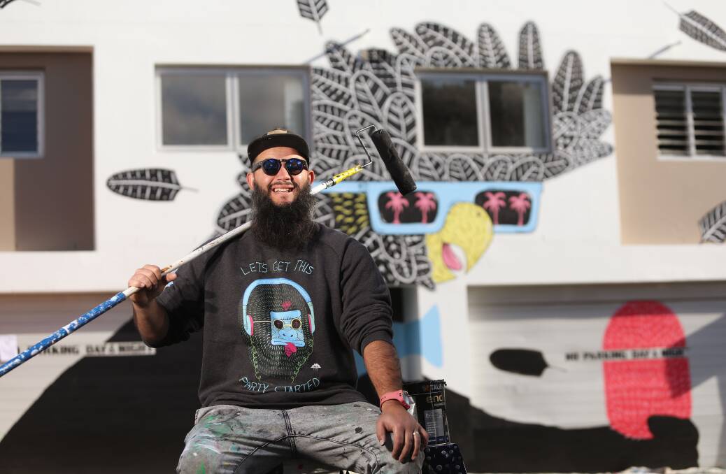 Cock-a-hoop about "Eberto": Miranda artist Joel Moore, aka Mulga, with the black cockatoo mural he painted as part of Inner West Council’s "Perfect Match" program. Picture: Daniel Munoz