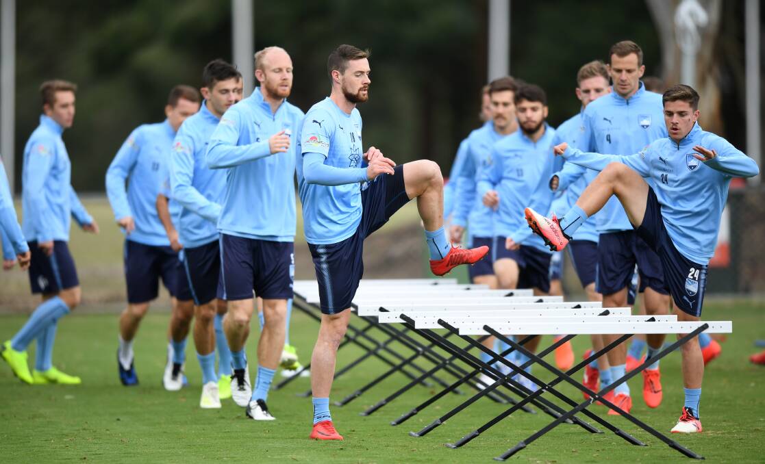 Jacob Tratt (front left) and Cameron Devlin (front right) are in talks about signing a new deal with Sydney FC for next season.