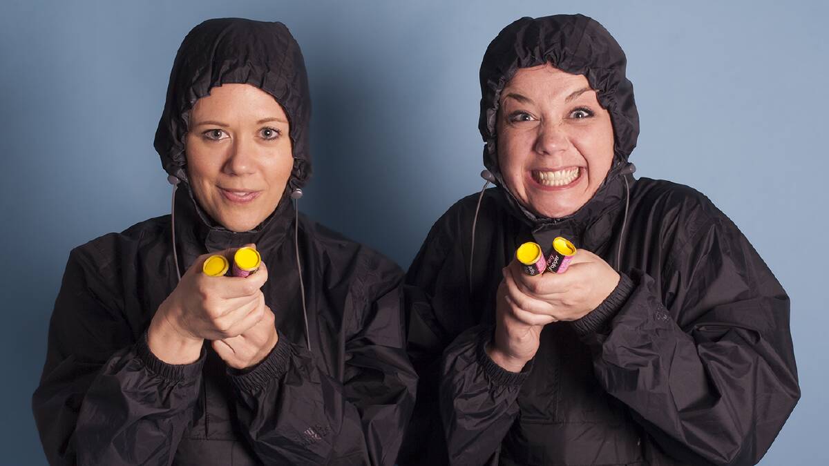 Silent double-act: Nicky Wilkinson and Claire Ford perform in the often tightly knotted hooded anoraks known in Britain as kagools.