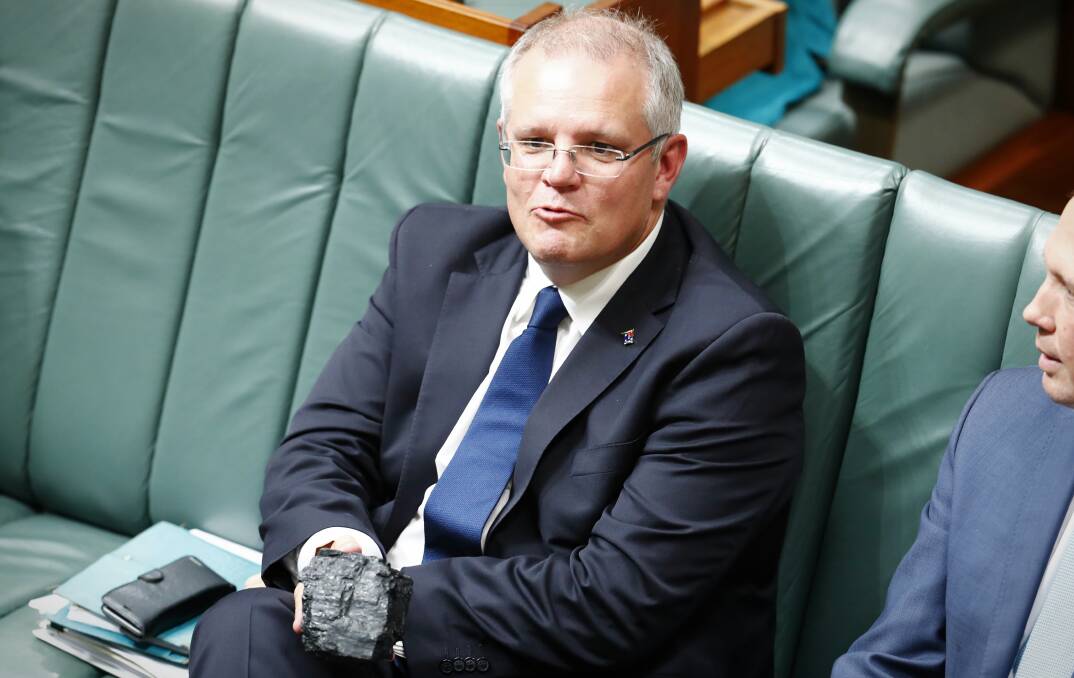 Burn baby burn: Treasurer Scott Morrison shows off his lump of coal during Question Time at Parliament House in Canberra on February 9.  Picture: Alex Ellinghausen