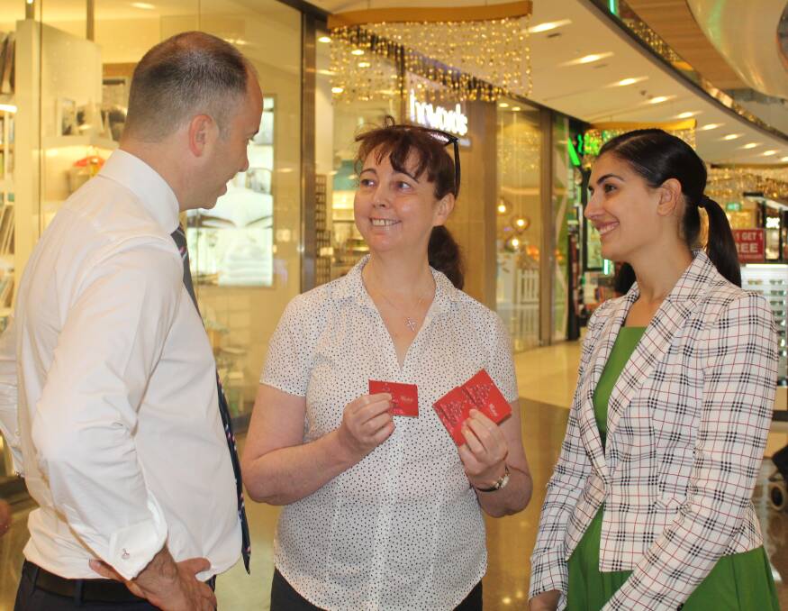 Love is in the air: Matt Kean and Eleni Petinos chat with Carolyn Cash (centre) while promoting the new gift card laws at Westfield Miranda last December around the time of the explicit texts. 