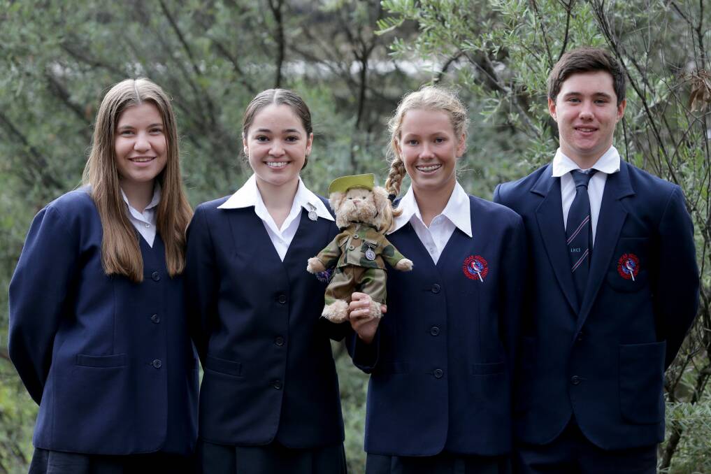 Lucas Heights Community School students Alicia Hull (left), Veronica Redman, Kristen Grundie and Ethan Waudby with their mascot Captain Lucas. Picture: Jane Dyson