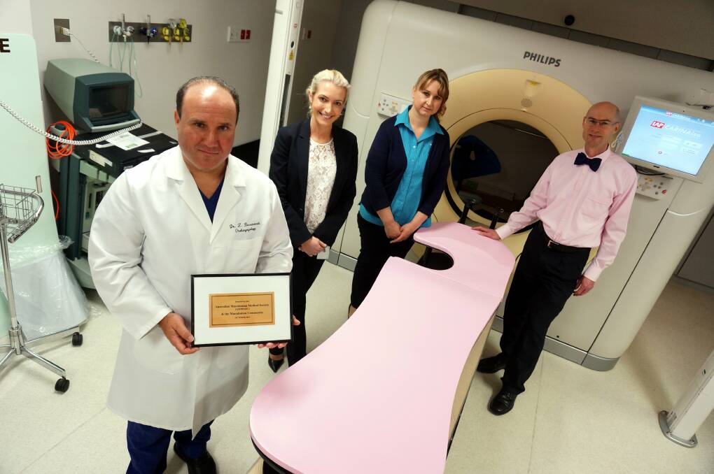 Tickled pink: Dr Zoran Becvarovski, radiation oncologist Dr Clare Suttie, senior radiation therapist Lilly Keremelovski and acting director of radiation oncology, Professor Peter Graham, with the equipment.