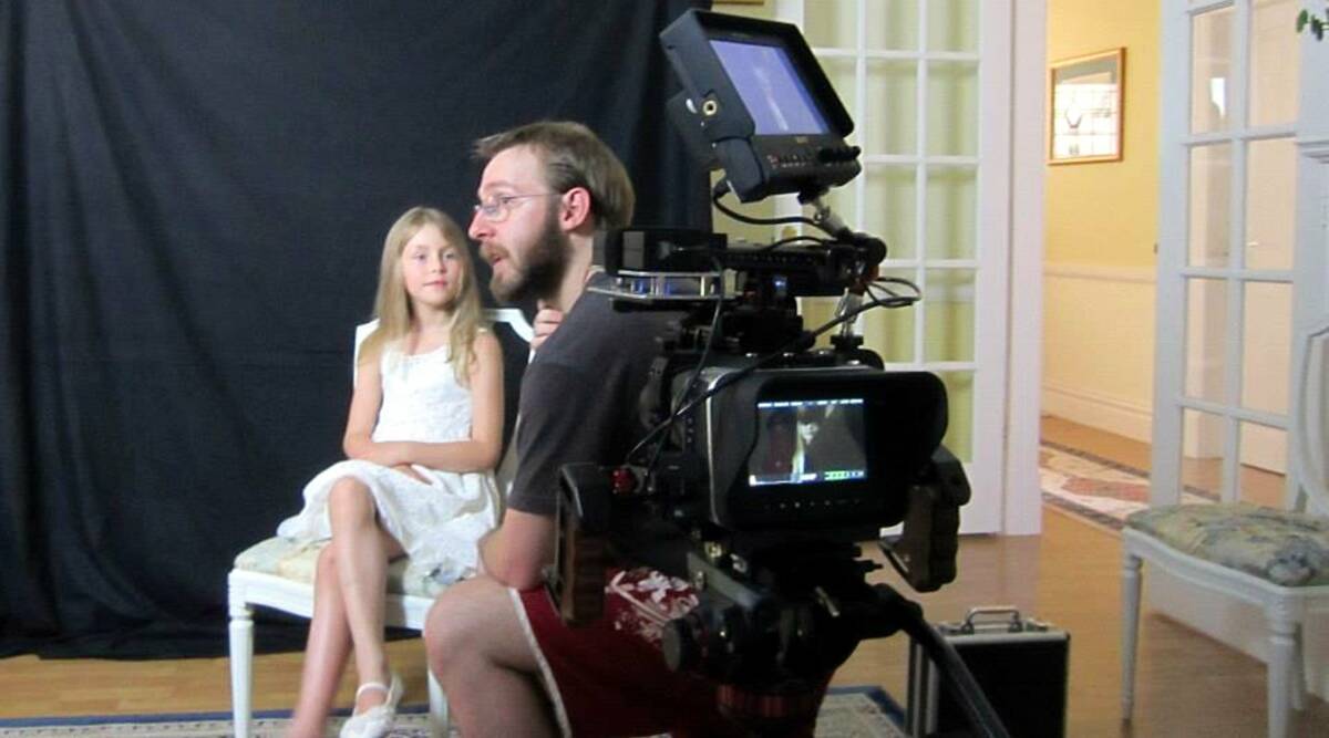 Rehearsal: Director Davo Hardy and young Pamela (played by Bridget Williams) on the set.
