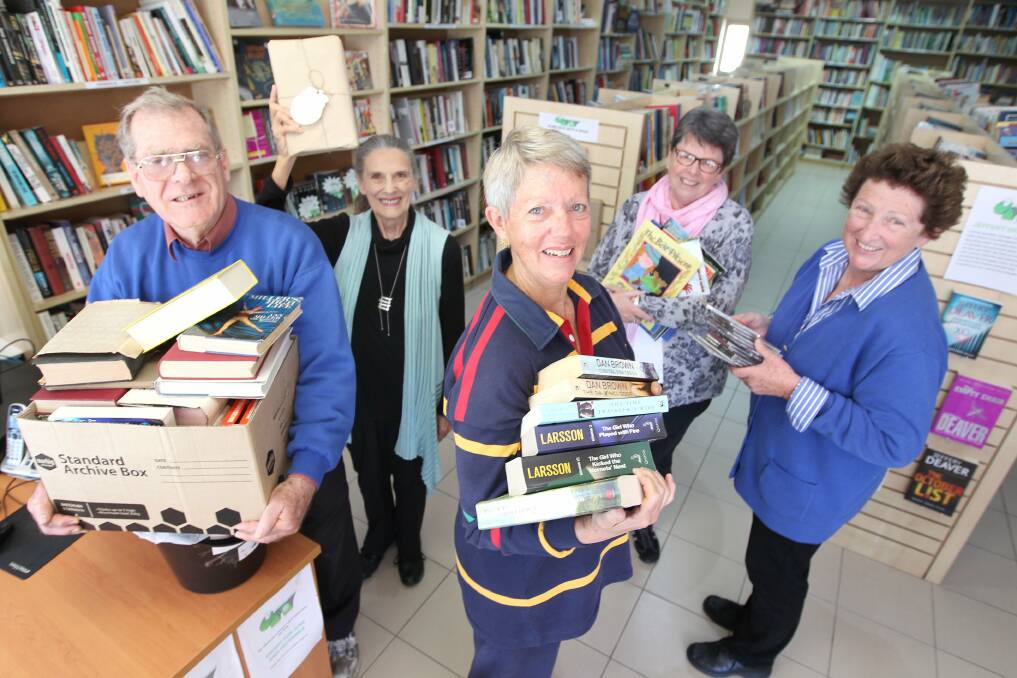 A haven for book lovers: Bookshop project manager James Forrester with some of the volunteers at Mulga Road Books. Picture: John Veage