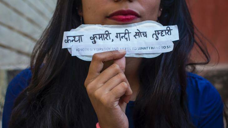A student holds a sanitary pad with feminist messages during the viral campaign #PadsAgainstSexism by students of Jamia Millia Islamia university in Delhi in March. Photo: Barcroft Media
