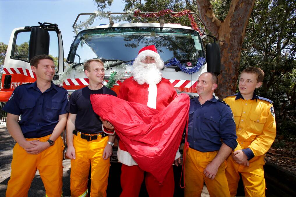 Christmas spirit: Grays Point RFS will celebrate 30 years of its Santa run this year. Left to right: Andrew Deards, Sean Dortkamp, Santa, Craig Byrne and Callum Leahy. Picture: Jane Dyson