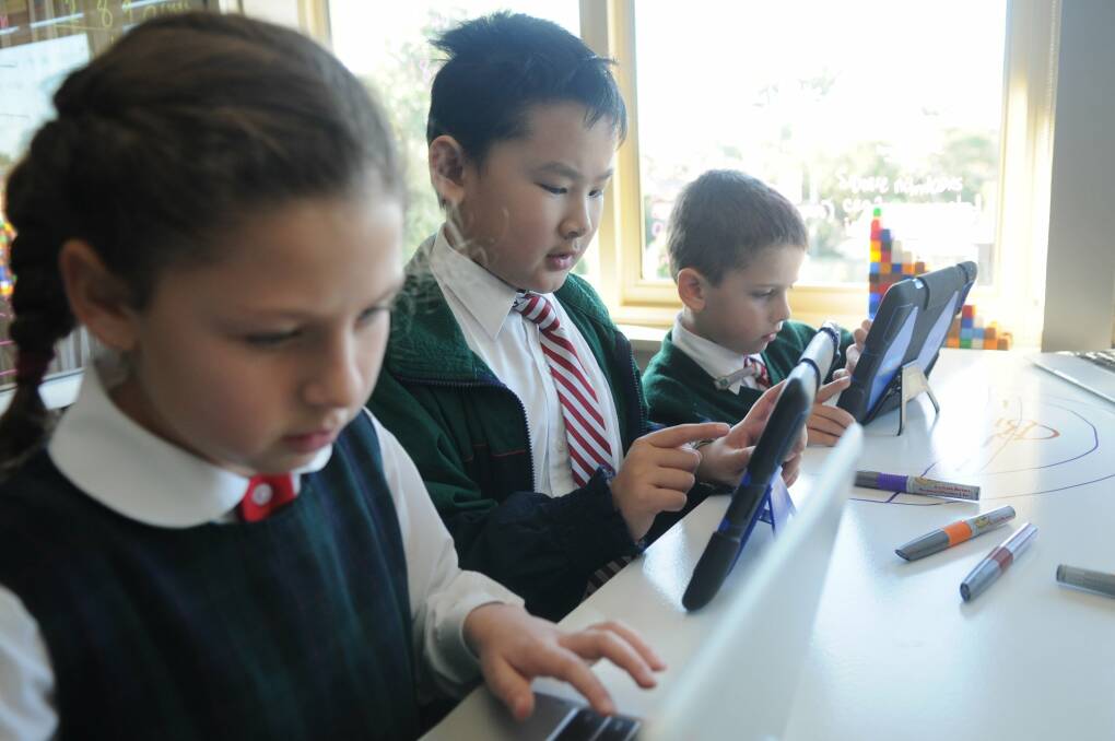 Digital age: Antonia Safi, Anthony Bui and Max Wyer are learning how to code at school.