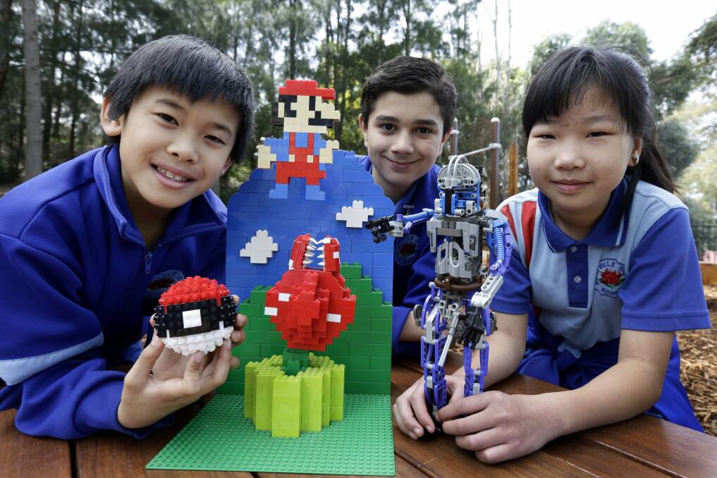Building for the future: Hurstville South Public School pupils Dylan Mak, Damian Scalone and Wennie Li are preparing to get building for their Lego fund-raiser. Picture: Anna Warr