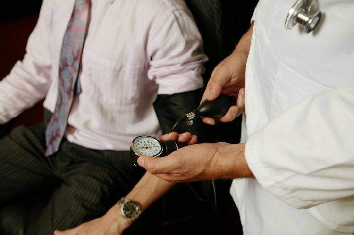 Generic set up photo of a doctor taking a businessman's blood pressure. 5 June 2006. AFR Photo by Andrew Quilty. Generic  doctor, health, blood pressure, businessman.blood pressure.jpg Doctor.