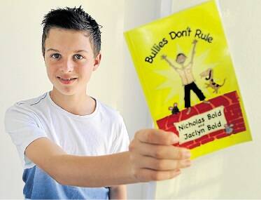 Words of advice: Inspired by his experiences of being bullied, Nicholas Bold, 11, wrote a book to help other children manage antisocial behaviour. Picture: John Veage