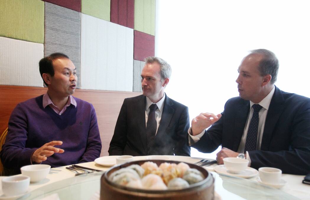 Tell the minister: Immigration Minister Peter Dutton (right) and Banks MP David Coleman talk with Sunny Chang. Picture Chris Lane