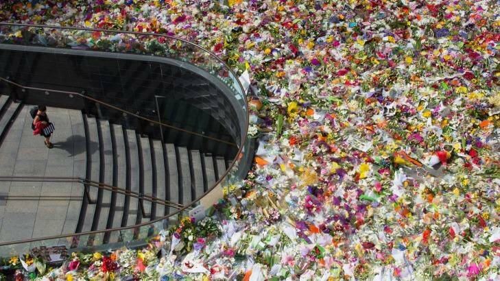 A rooftop view shows Martin Place heaving with floral tributes.  Photo: Cole Bennetts