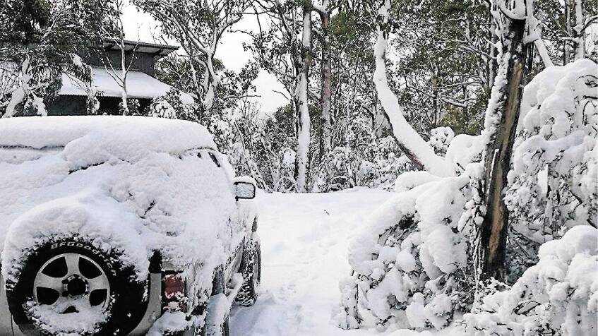HERE TO STAY: Jessica Linger’s picture of a snow-covered 4WD taken at Cradle Mountain. 
