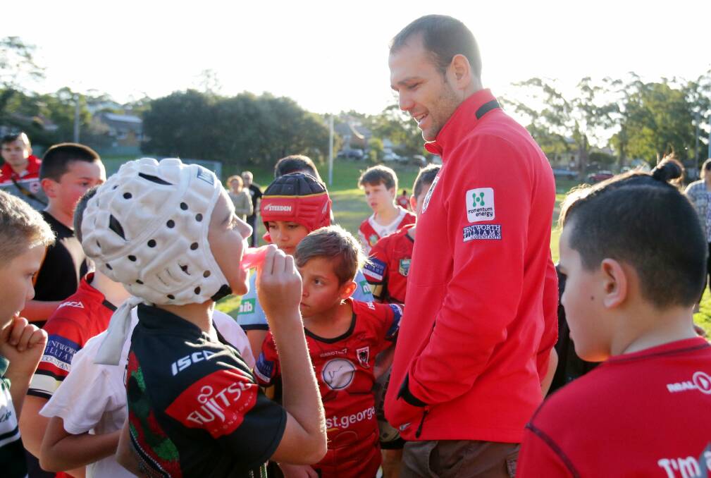 Back where it all began: Dragons winger Jason Nightingale mixes with Renown United juniors at Renown Park on Tuesday. Picture: Chris Lane