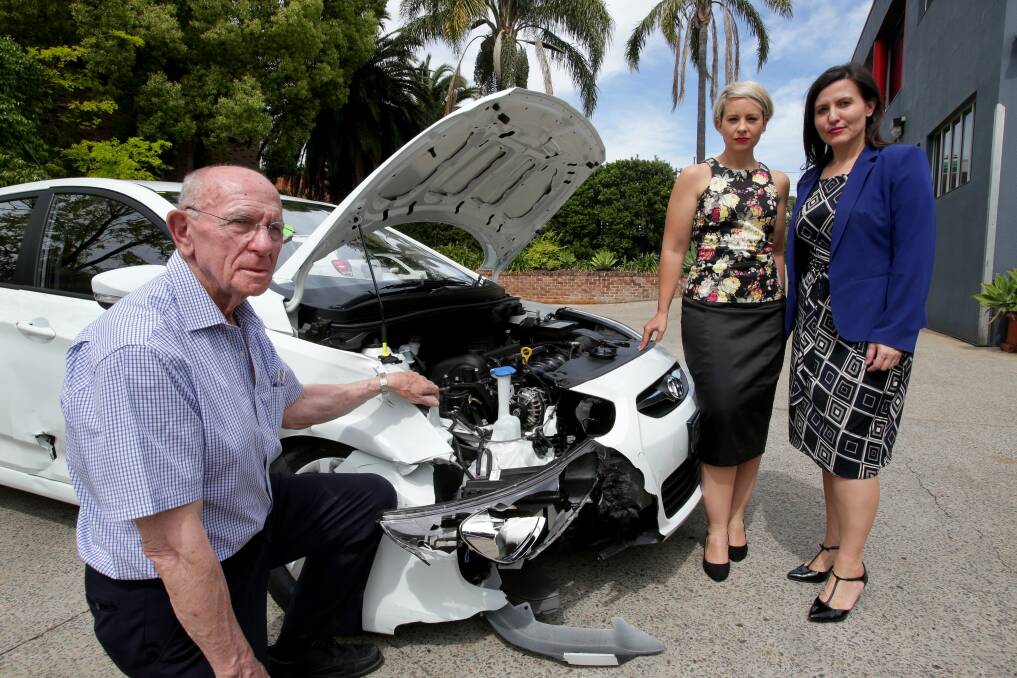 Motorists beware: Terry Flanagan shows a smashed car to Tania Mihailuk (right) and O'Bray Smith. Picture: Jane Dyson