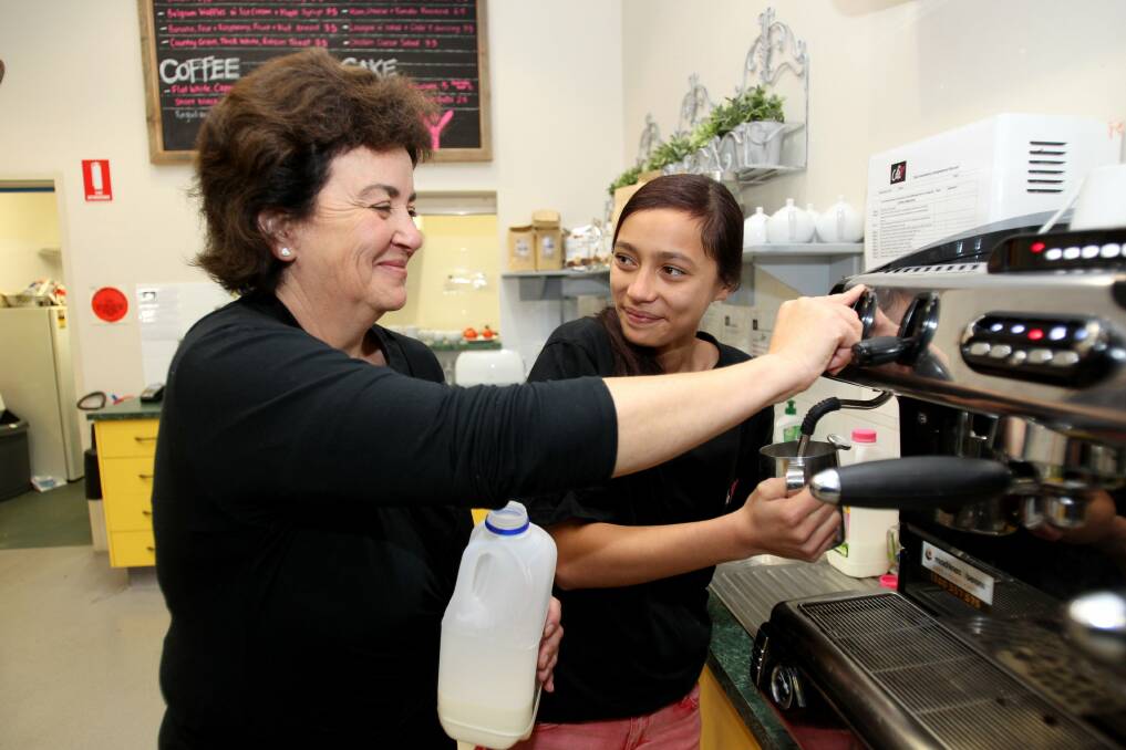 Social hub: Cafe manager Liane Casaceli takes Jacinta Chapman-Rare through training. Picture: Jane Dyson