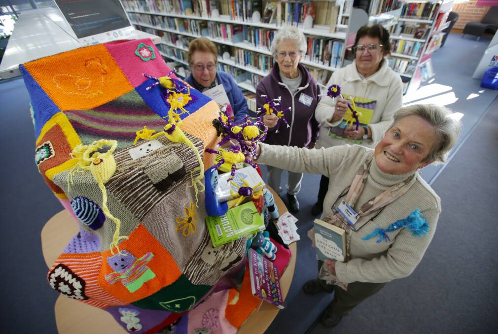 All in the mind: Members of the Nifty Knitters with their brain challenge blanket which is on display at Caringbah Library. Picture: John Veage

