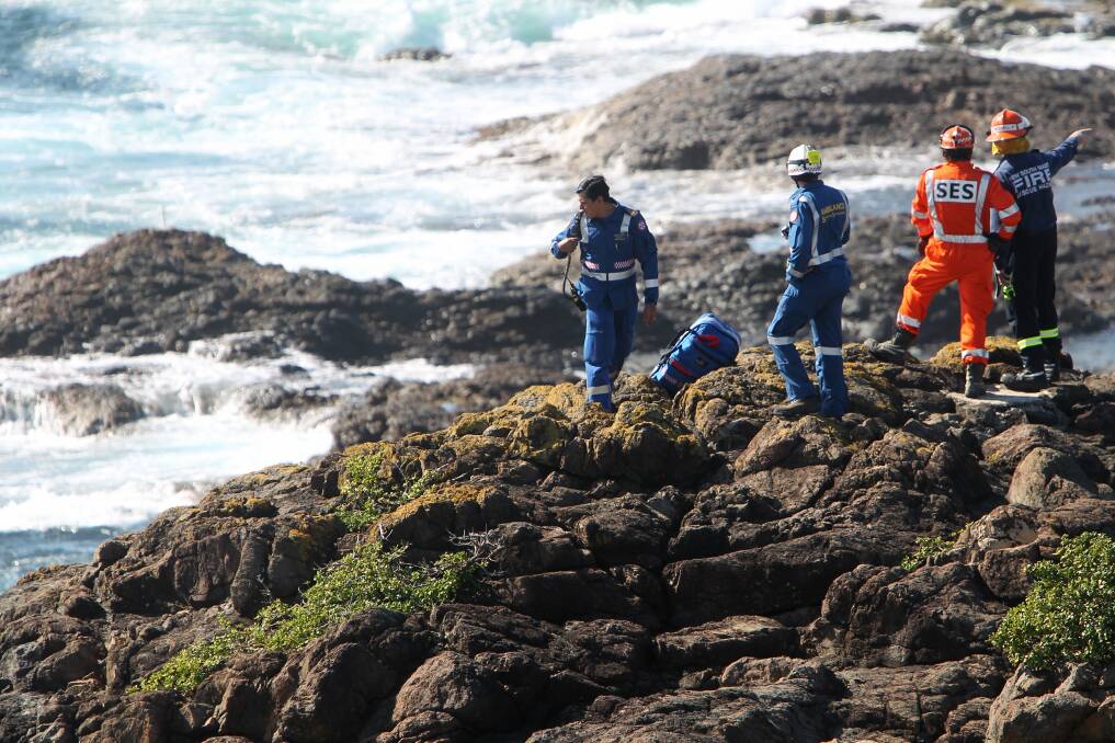 Swept away: Rescuers search for a missing rock fisherman at Kiama last year.