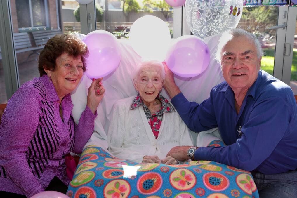 Always cheerful: Marie and Alan Bonney help Betty Hampel celebrate her 108th birthday. Picture: Jane Dyson
