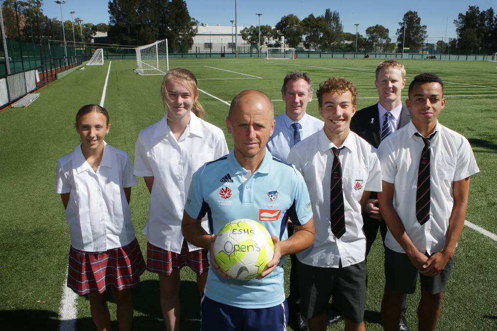 Game on: Students Tanya Marjanovic and Emily Thurgar, Sydney FC Academy director Kelly Cross, Endeavour Sports High School head of football Chris Bradley and principal James Kozlowski with students Perry Thomas and Ben Folami at the oval. Picture: John Veage