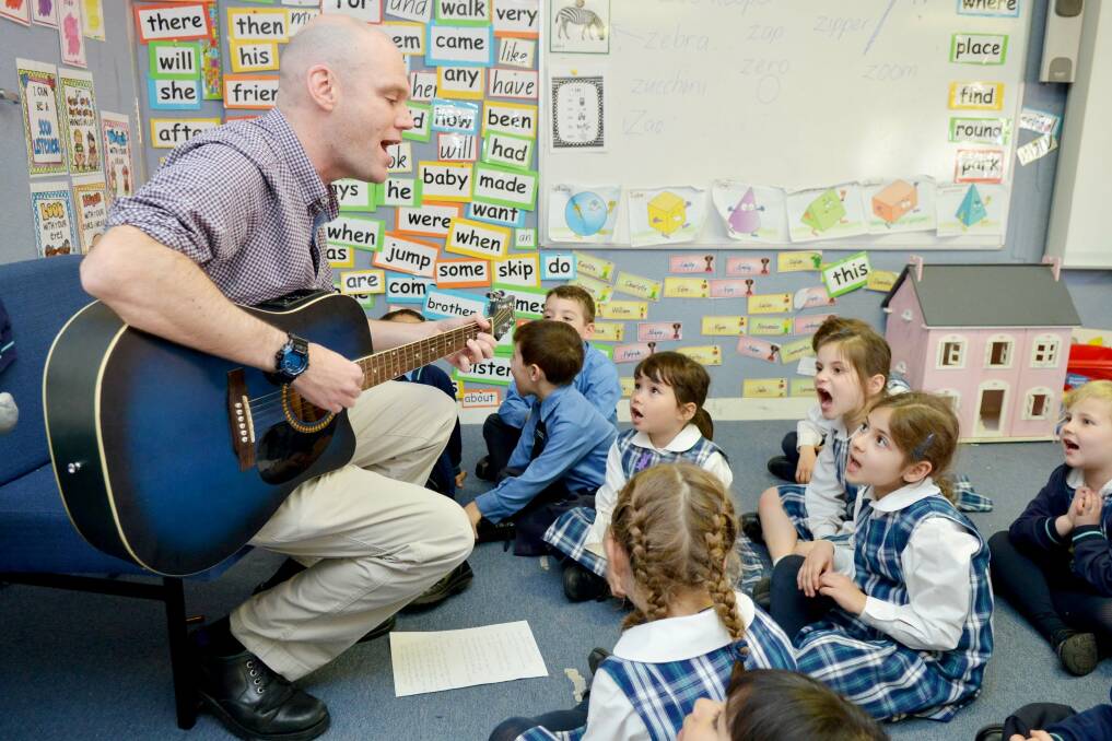 Music man: Dan Colquhoun uses songs to keep his kindergarten students focused and engaged.