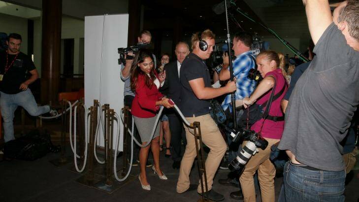 Members of the media almost trip over a bollard after a Parliamentary security guard put it in their way while interviewing Communications Minister Malcolm Turnbull. Photo: Alex Ellinghausen